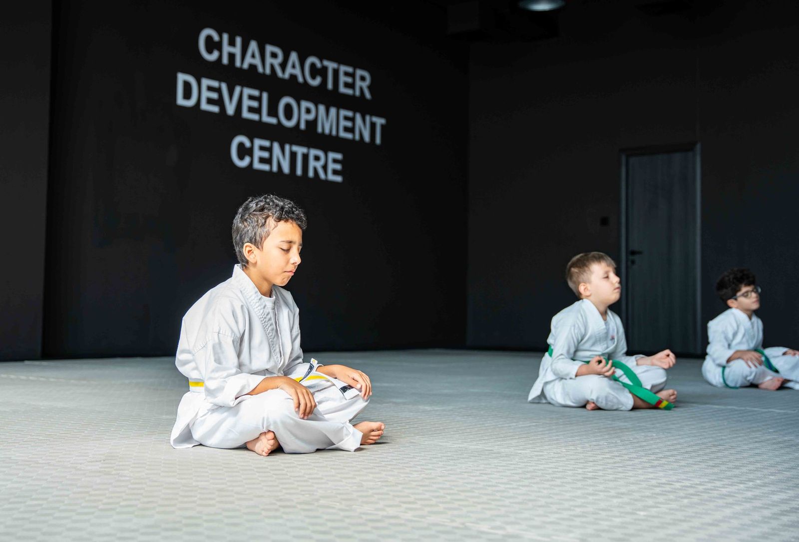 Young students meditating at the start of class in a Warrior Academy Character Development Centre