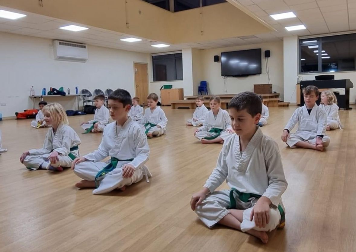 Students sitting in a focused line at our Bath club
