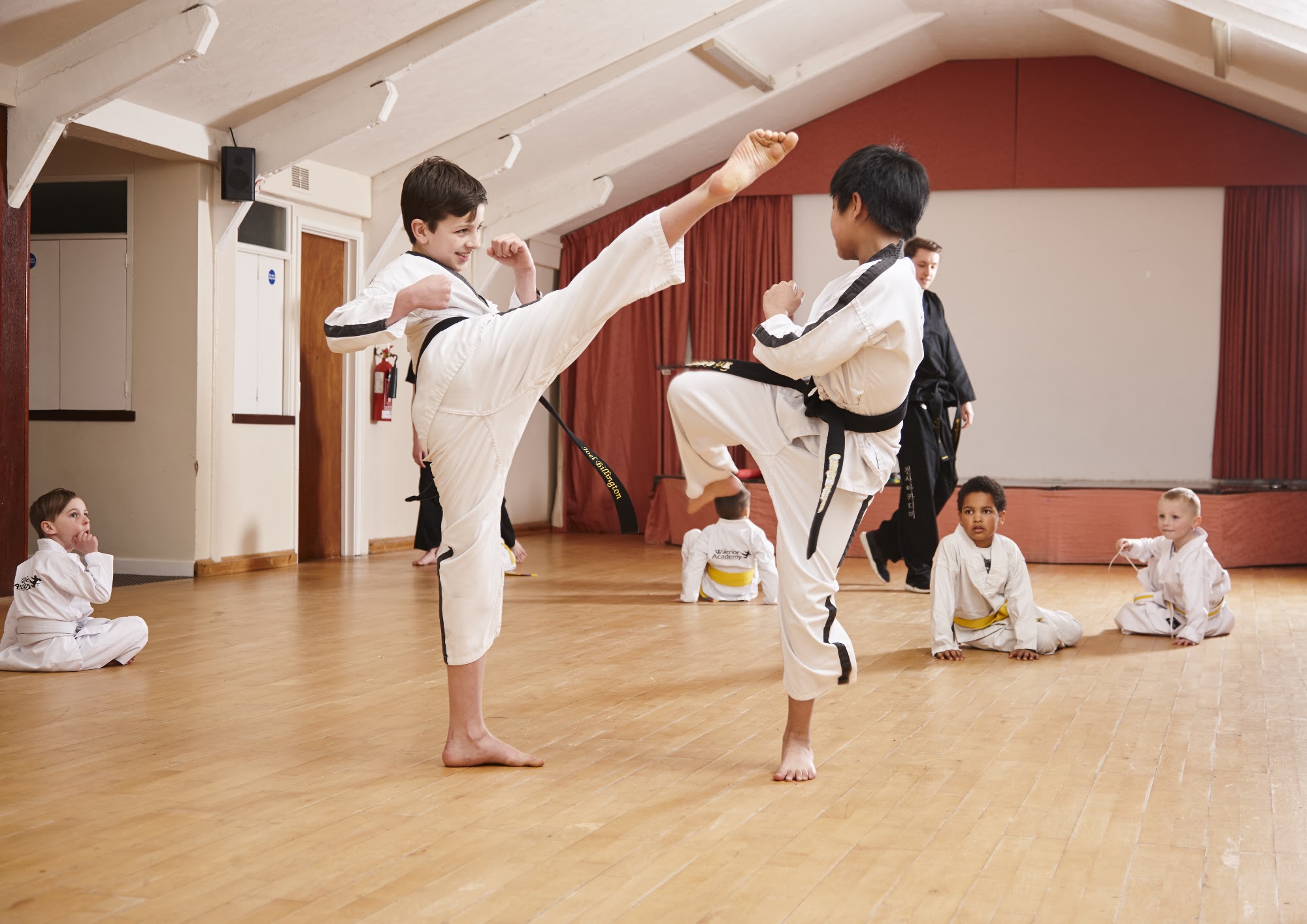 A senior student kicking in class at Rode